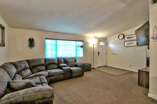 a living room with a leather couch and a television at The Haire Haus in Nampa