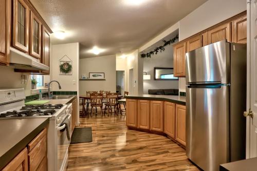 a kitchen with wooden cabinets and a stainless steel refrigerator at The Haire Haus in Nampa