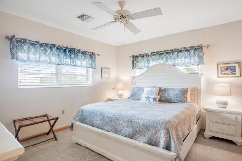 a bedroom with a bed and a ceiling fan at The Nautical Nimbus in Big Pine Key