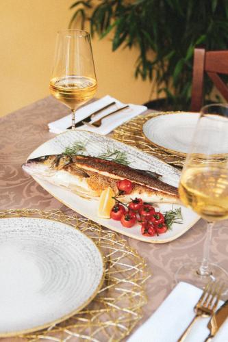 a table with plates of food and glasses of wine at Operna klet Ljubljana in Ljubljana