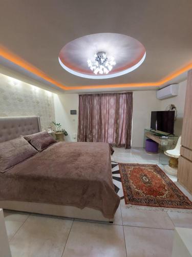 a bedroom with a large bed and a large ceiling at Aphrodite View in Korakiaí