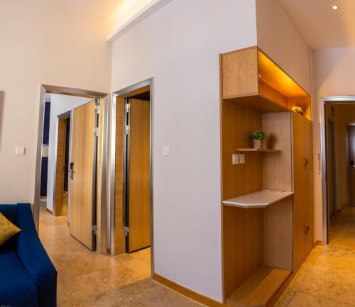 a room with a hallway with wooden shelves at VANCII Hotel in Chefchaouene