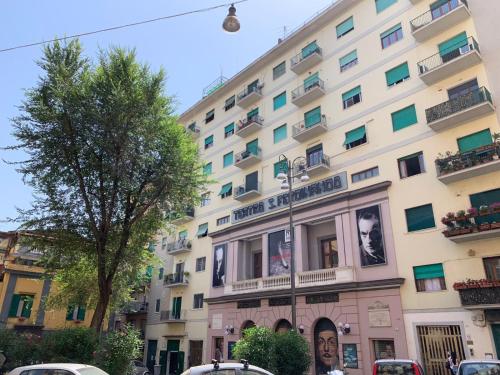 a large building with cars parked in front of it at VIVI A NAPOLI in Naples