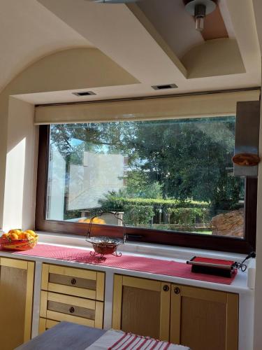 a kitchen with a large window and a counter top at Aphrodite View in Korakiaí
