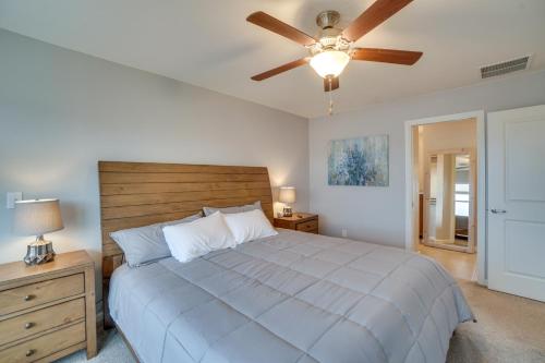 a bedroom with a bed and a ceiling fan at Suburban Denver Home with Fire Pit and Shuffleboard! in Denver