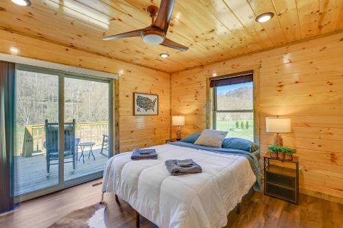 a bedroom with a bed in a log cabin at Riverside Beattyville Cabin with Kayaks and Fire Pit! in Beattyville