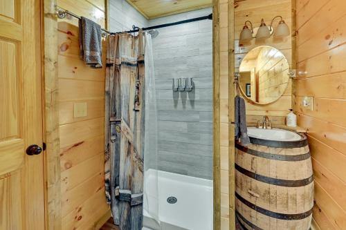a bathroom with a shower and a sink and a mirror at Riverside Beattyville Cabin with Kayaks and Fire Pit! in Beattyville