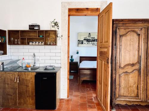 a kitchen with a door leading to a bedroom at Haifa Vintage Studios in Haifa