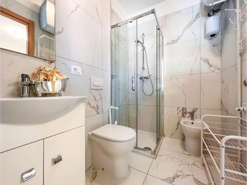 a bathroom with a shower and a toilet and a sink at Zeus in Bibione