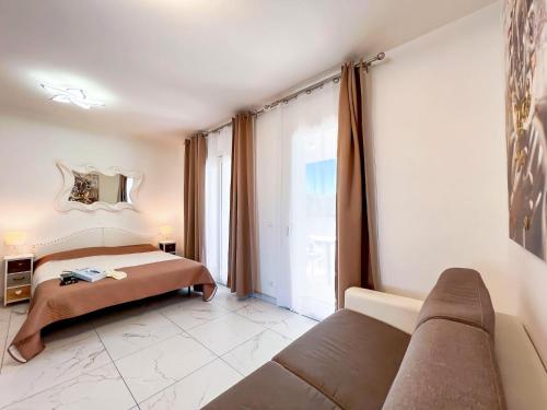 a bedroom with a bed and a couch in it at Zeus in Bibione