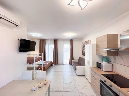a white living room with a kitchen and a living room at Zeus in Bibione