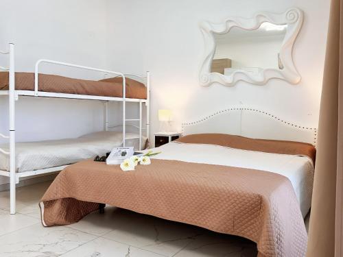 a bedroom with two bunk beds and a mirror at Zeus in Bibione