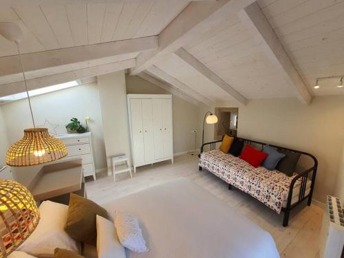 a living room with a bed and a couch at Casa con encanto en Laxe in Laxe