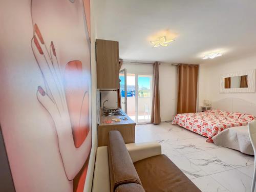 a room with a bedroom with a bed and a window at Zeus in Bibione