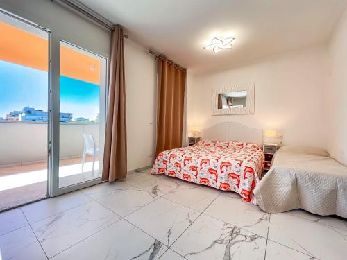 a bedroom with a bed and a large window at Zeus in Bibione