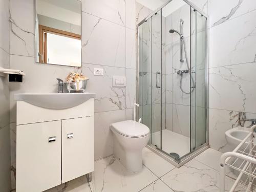 a bathroom with a shower and a toilet and a sink at Zeus in Bibione