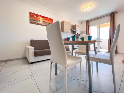 a dining room with a table and chairs at Zeus in Bibione