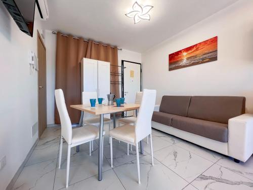 a dining room with a table and a couch at Zeus in Bibione