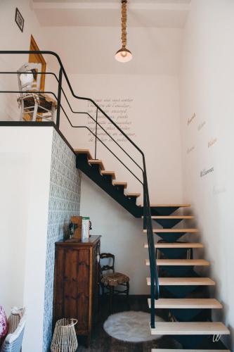 a staircase in a living room with a stair case at Au charme d'antan in Féron