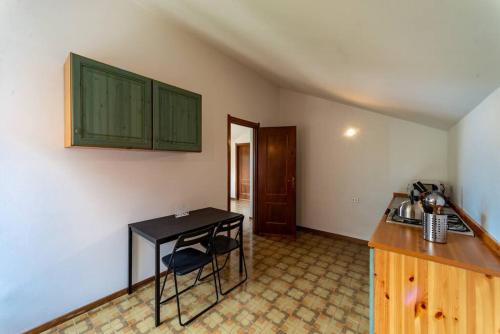 a kitchen with a black table and a counter at Bologna House in Perledo
