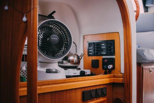 a fan sitting on a shelf in a room at House boat FreeInDeed in Bar