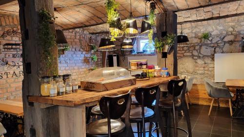 a bar in a restaurant with stools at a counter at Hiša stare mame in Kamnik