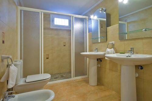 a bathroom with a shower and a toilet and a sink at Villa Calalga - PlusHolidays in Calpe
