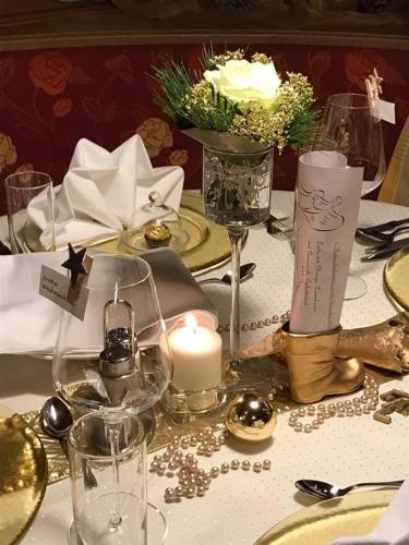a table with a white candle and a white table cloth at Hotel Brunnenhof in Neustift im Stubaital