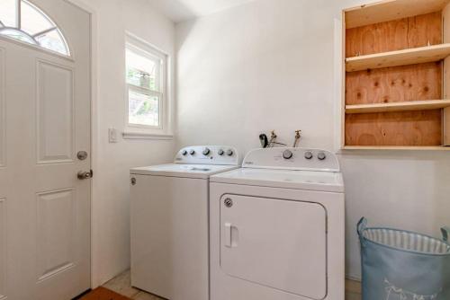 a white laundry room with a washer and dryer at Maple Retreat, 5 min to Bass Lake,12 mi to Yosemite, Themed and Decorated in Oakhurst