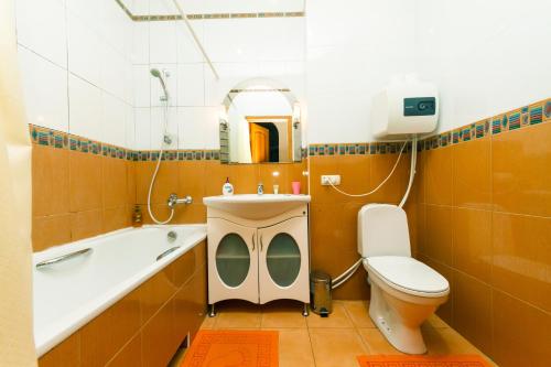 a bathroom with a tub and a toilet and a sink at Apartment on Independence Square in Kyiv