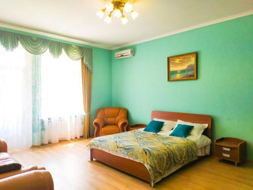a bedroom with a bed and a chair at Apartment on Independence Square in Kyiv
