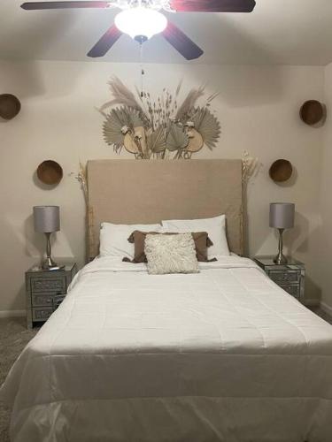 a bedroom with a large white bed with two lamps at Pink Tulum Houston 2min from Galleria in Houston