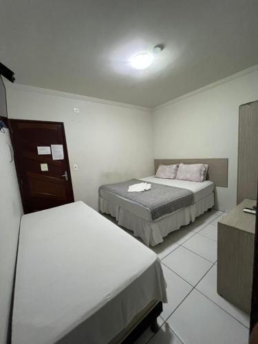 una habitación de hotel con 2 camas en una habitación en Pousada Nacional Orla, en Maragogi