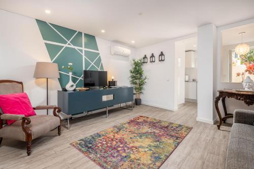 a living room with a blue cabinet and a rug at Designer Flats in Lapa by LovelyStay in Lisbon