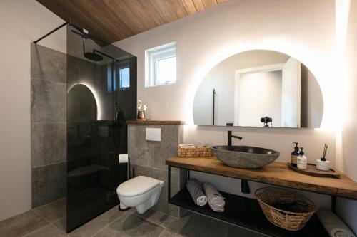 a bathroom with a sink and a shower at Holt Villa in Reykholt
