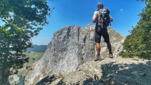 a man standing on top of a rocky mountain at Villa Belvedere in Pieve Fosciana