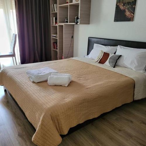 a bedroom with a large bed with two towels on it at COSY APARTMENT IN VERIA in Veria