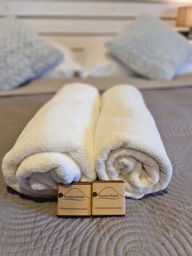 two towels are sitting on top of a bed at Pension Růžák in Růžová