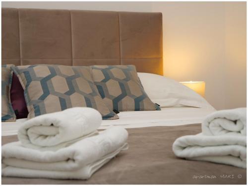 a bedroom with a bed with towels on it at MARI in Dolac