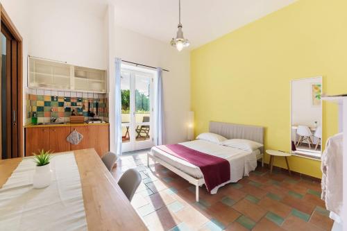 a bedroom with a bed and a table in it at Le Grand Bleu - Gioia Apartments in Procida