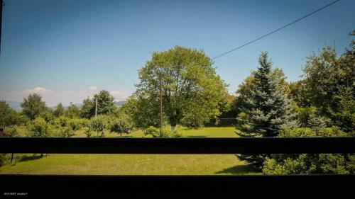 a view of a field from a train window at Green Forest Visoko in Visoko