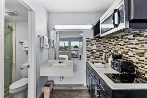 a small bathroom with a sink and a toilet at Studio 6 Wilmington, NC in Wilmington