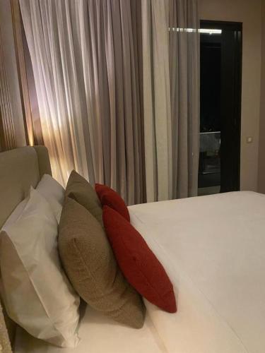 a bed with some pillows on it in a room at Anfa Place, Luxury Apartment just renovated, Ocean View in Casablanca
