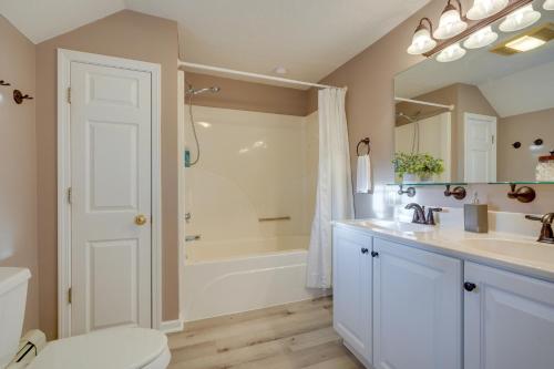 a bathroom with a tub and a sink and a toilet at Coudersport Home with Outdoor Spa and Stargazing! in Coudersport