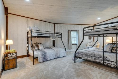 a bedroom with two bunk beds in it at Coudersport Home with Outdoor Spa and Stargazing! in Coudersport