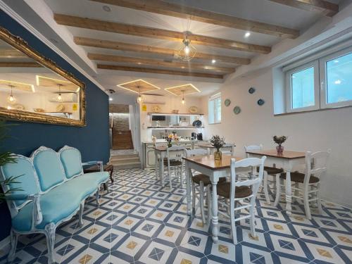 a dining room with blue chairs and tables at Baia do Mundo in Setúbal