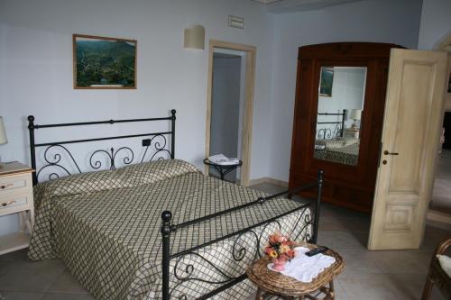 a bedroom with a bed and a mirror at Casa Vacanze San Francesco in Bagni San Filippo