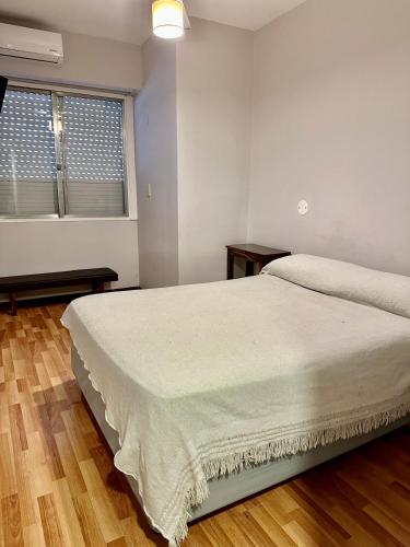 a bedroom with a large bed and two windows at Hotel Hey U in Santa Fe