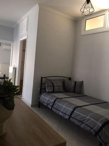 a bedroom with a bed in the corner of a room at Three Graces in Nafplio in Nafplio