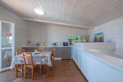 a kitchen with a table and chairs in a room at Villa Barnaba Country House & Pool in Polignano a Mare